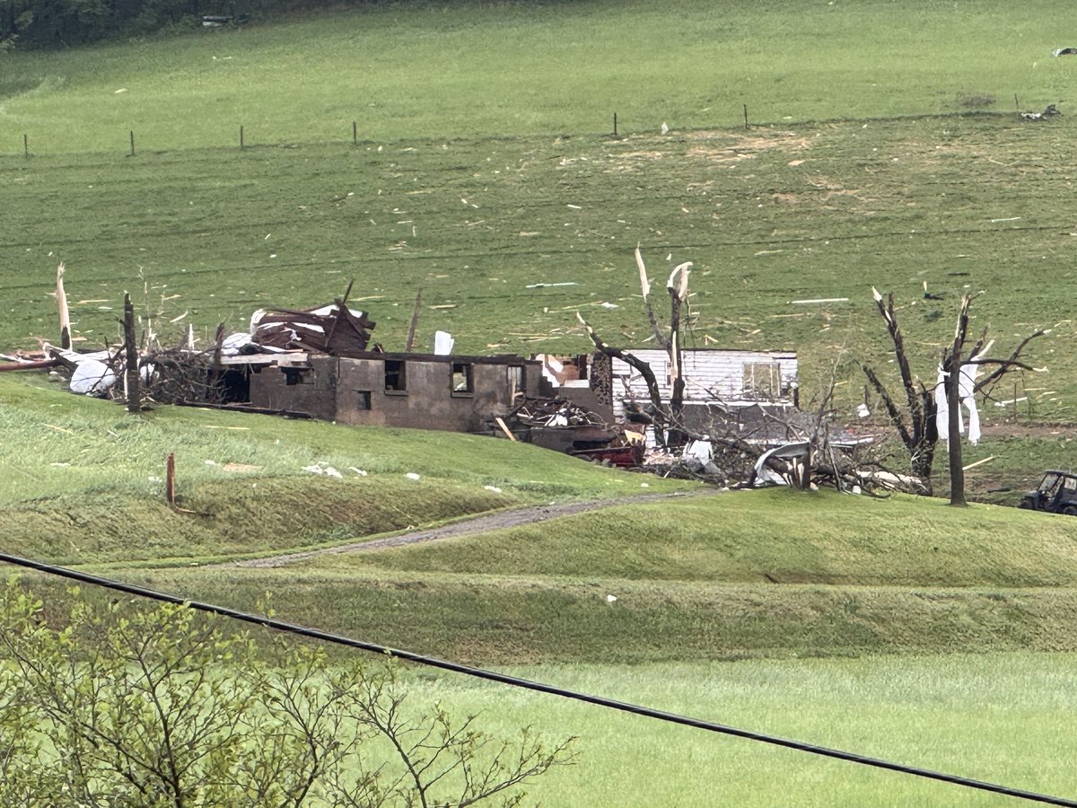 Scene in Fairhaven, WV, not far from the PA border. Severe weather damage has ripped the roof off a home. Power poles are down, debris scattered throughout a field