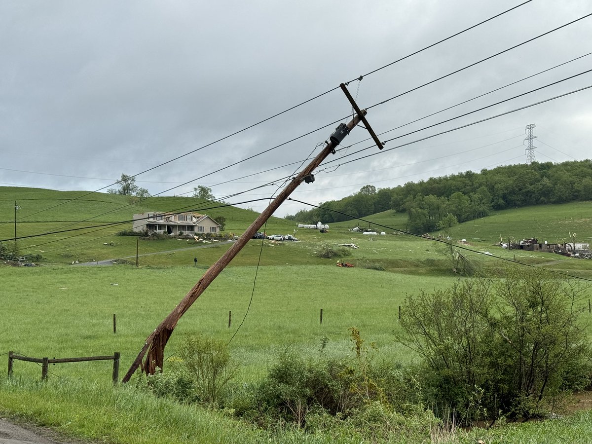 Scene in Fairhaven, WV, not far from the PA border. Severe weather damage has ripped the roof off a home. Power poles are down, debris scattered throughout a field